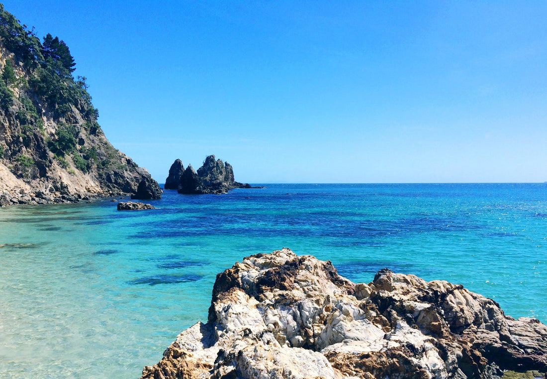 crystal clear turquoise ocean with rock formations